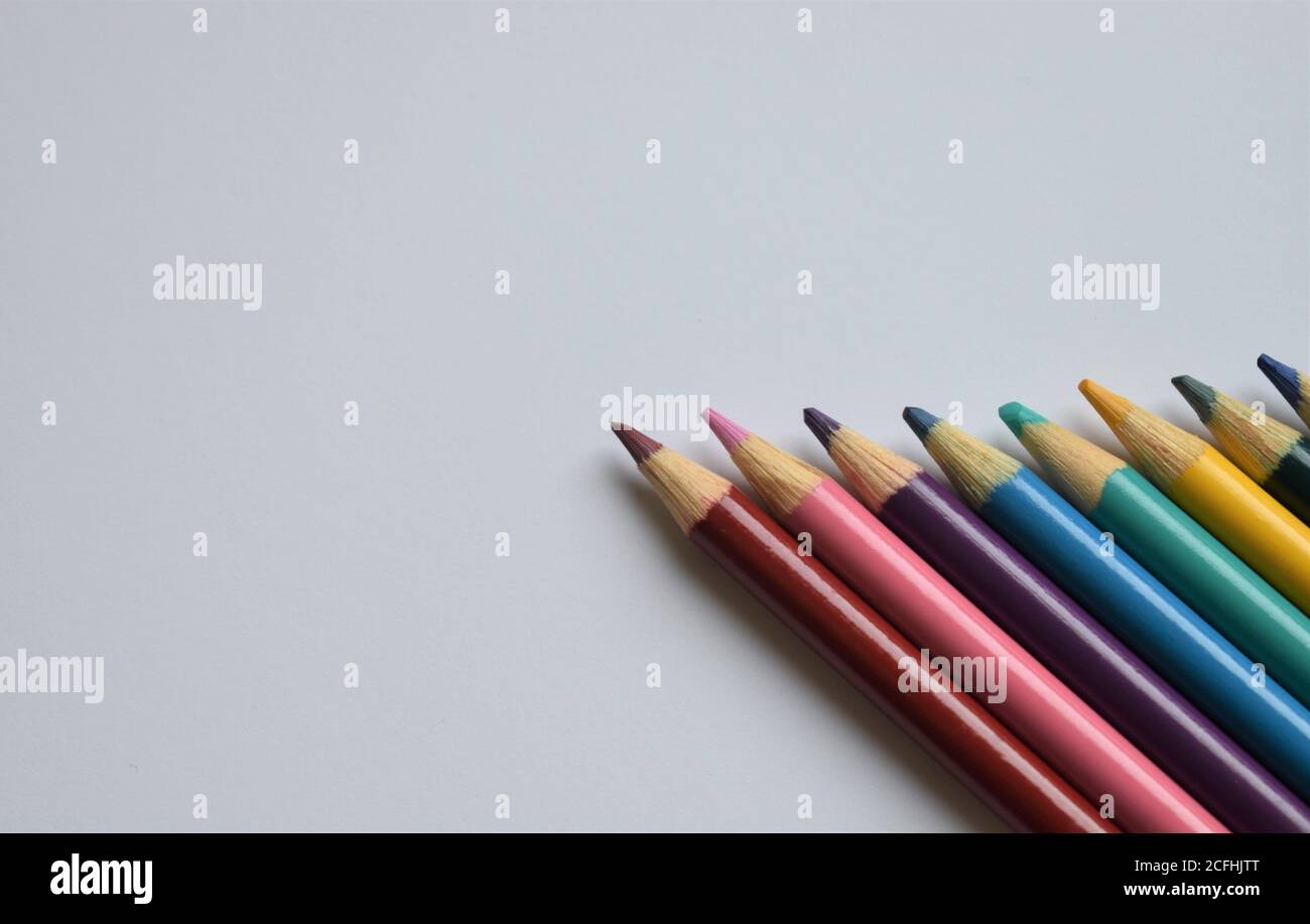 A neat row of colored pencils on a white background with copy space Stock Photo