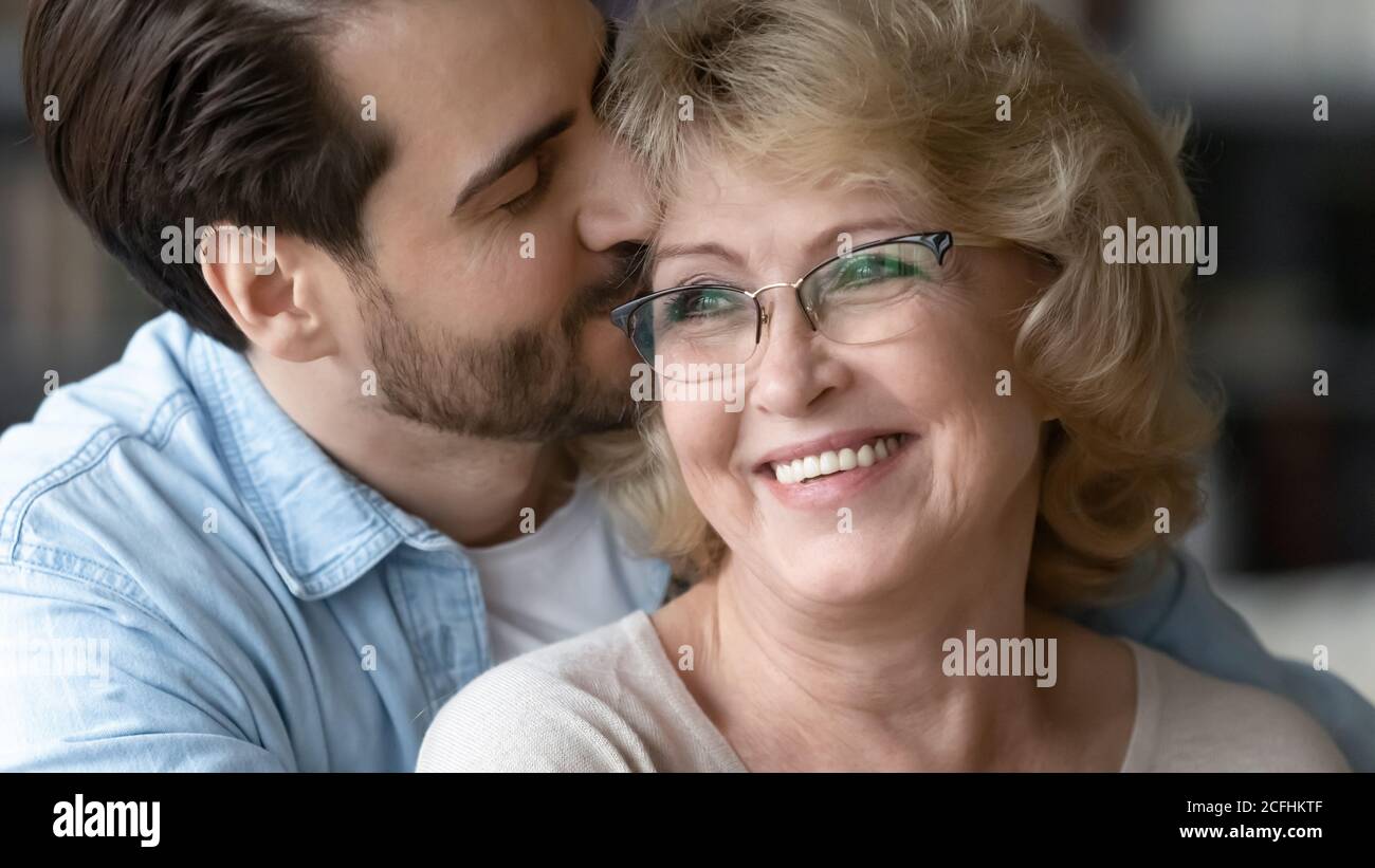 Mature woman and young man kissing hires stock photography and images