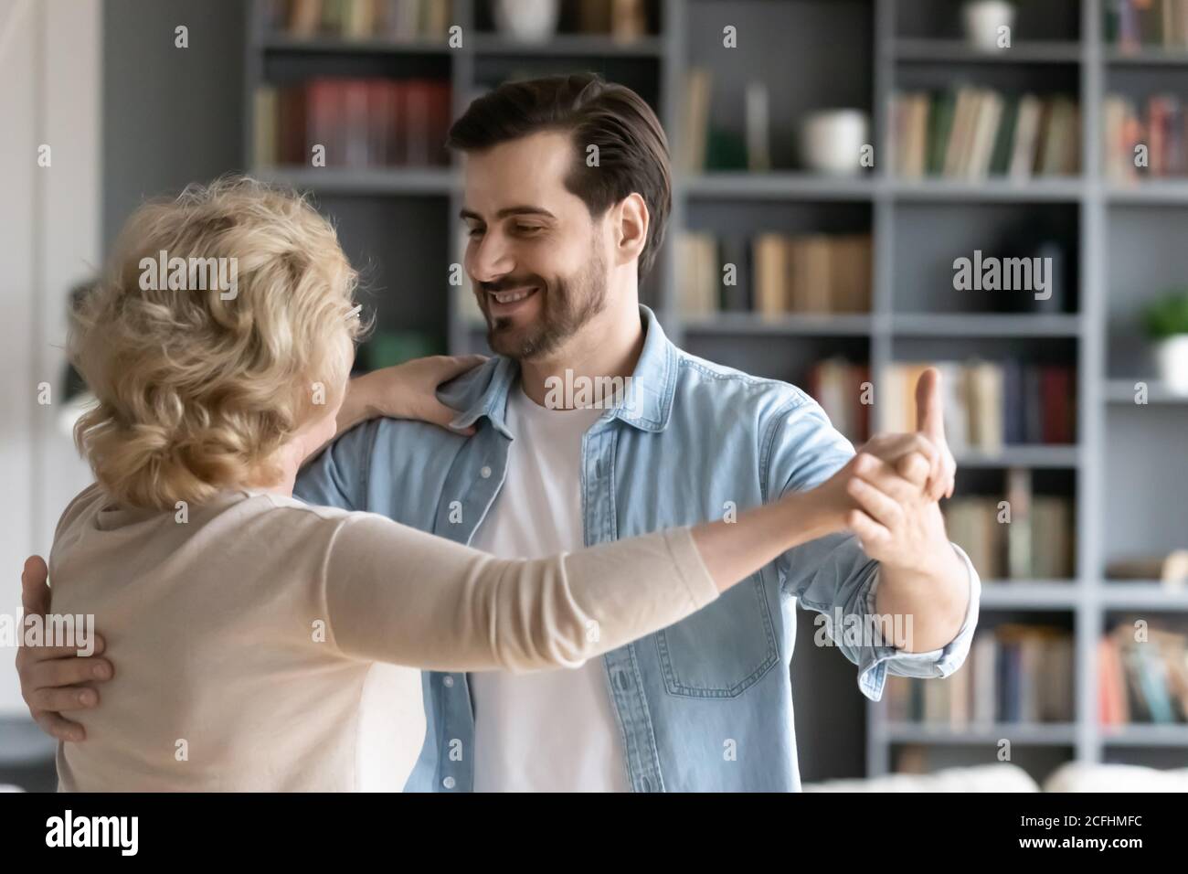 Close up smiling adult son dancing with mature mother Stock Photo