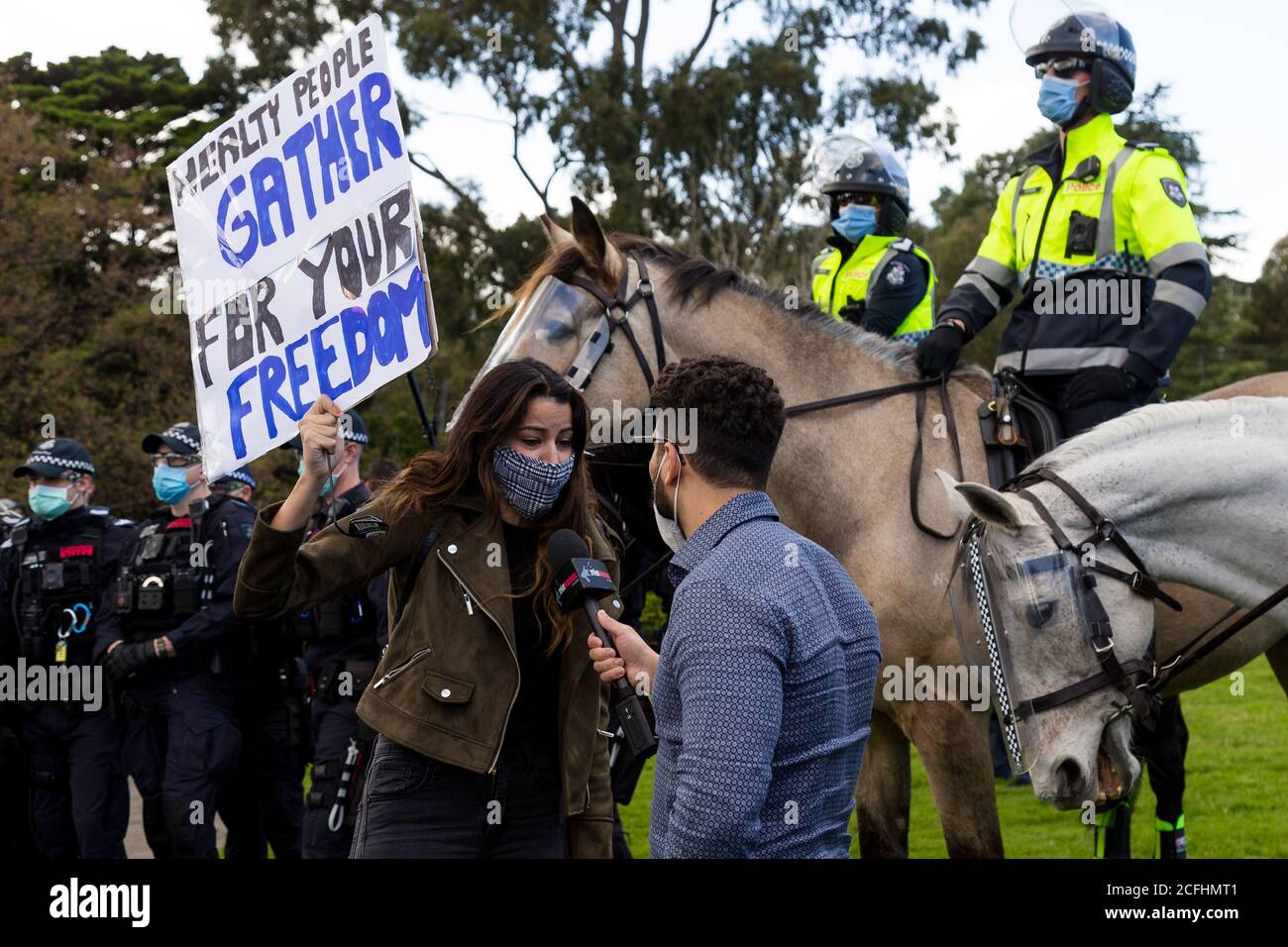 Melbourne, Australia, 5 September, 2020. A woman is interviewed by media flanked by mounted police during the Melbourne Freedom Protest, Phillip Island Circuit, Australia. Credit: Dave Hewison/Alamy Live News Stock Photo