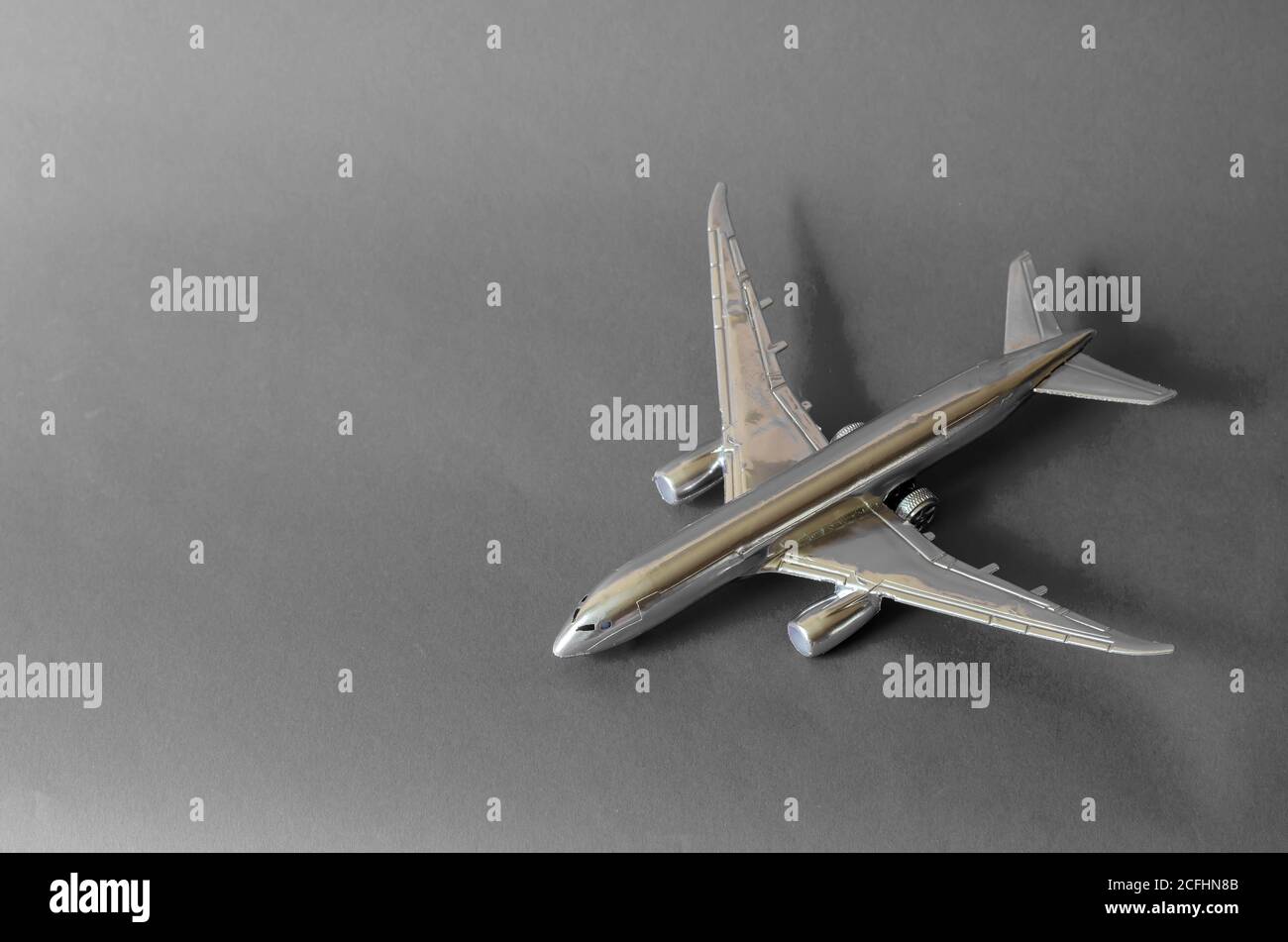 Silver airplane model on a gray background. Toy plane. Copy space ...