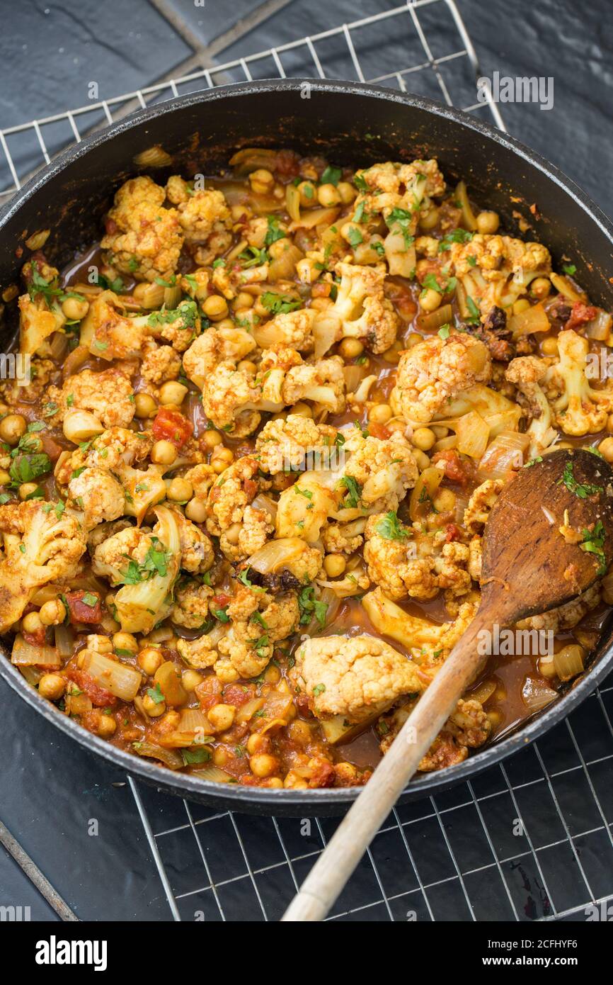 Curried cauliflower with chickpeas and tomatoes Stock Photo