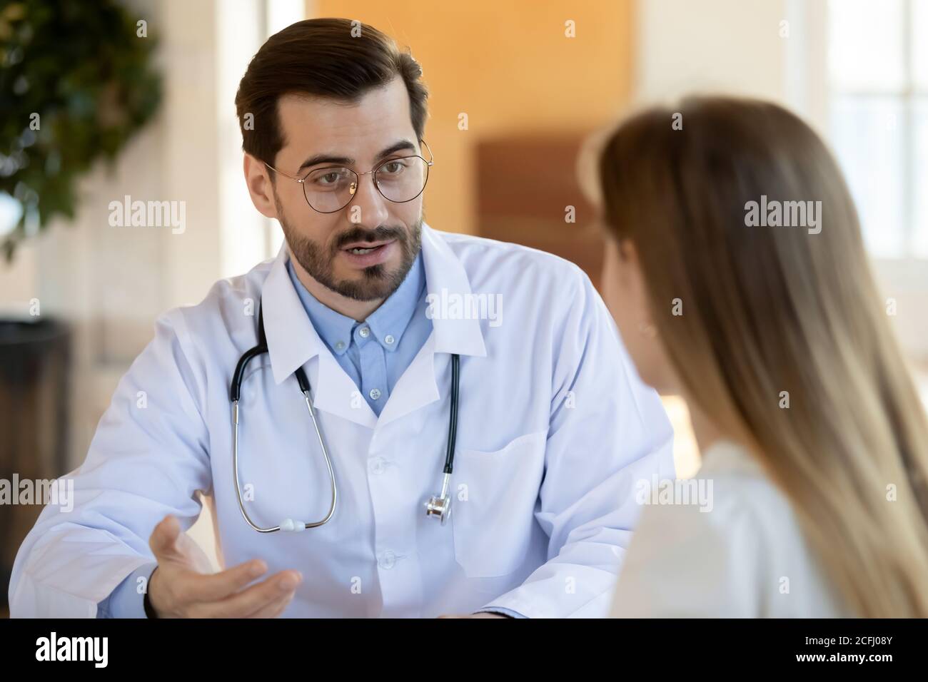Doctor consulting woman hi-res stock photography and images - Alamy