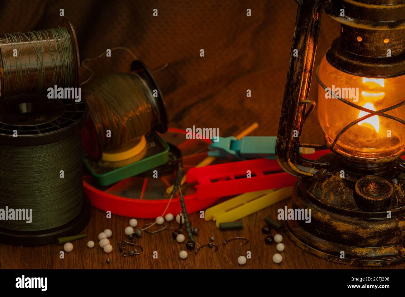 fishing line, hooks, sinkers, tools illuminated by an antique kerosene lamp Stock Photo Alamy