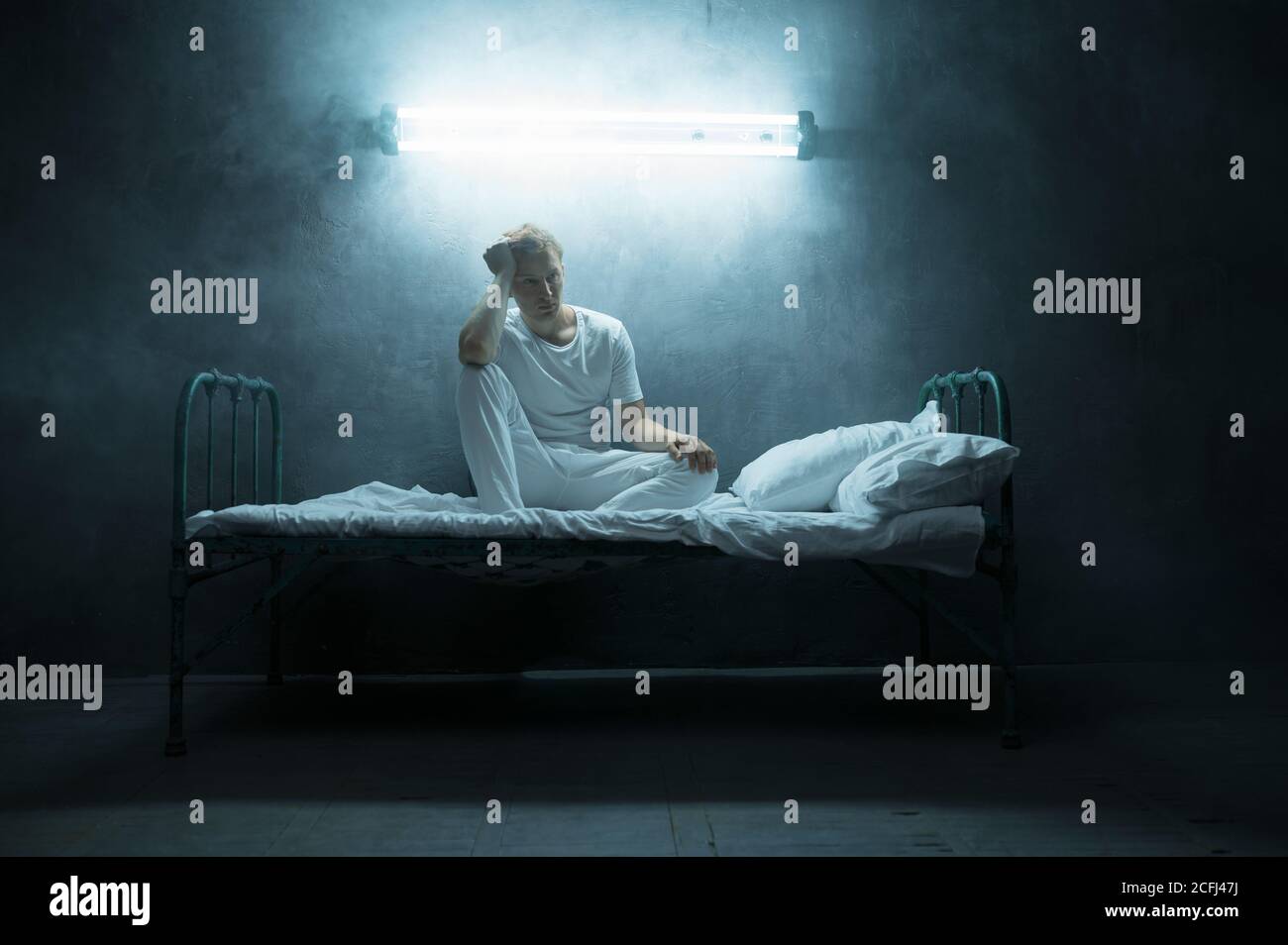 Mysterious image of a blindfolded man in a dark room stock photo