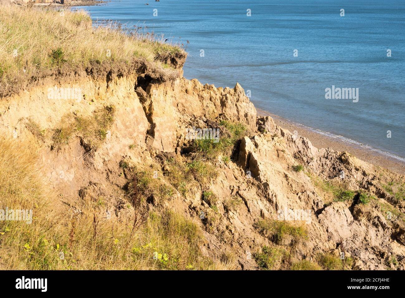 Crumbling cliffs along the England Coast path through Durham between Seaham and Ryhope, north east England, UK Stock Photo