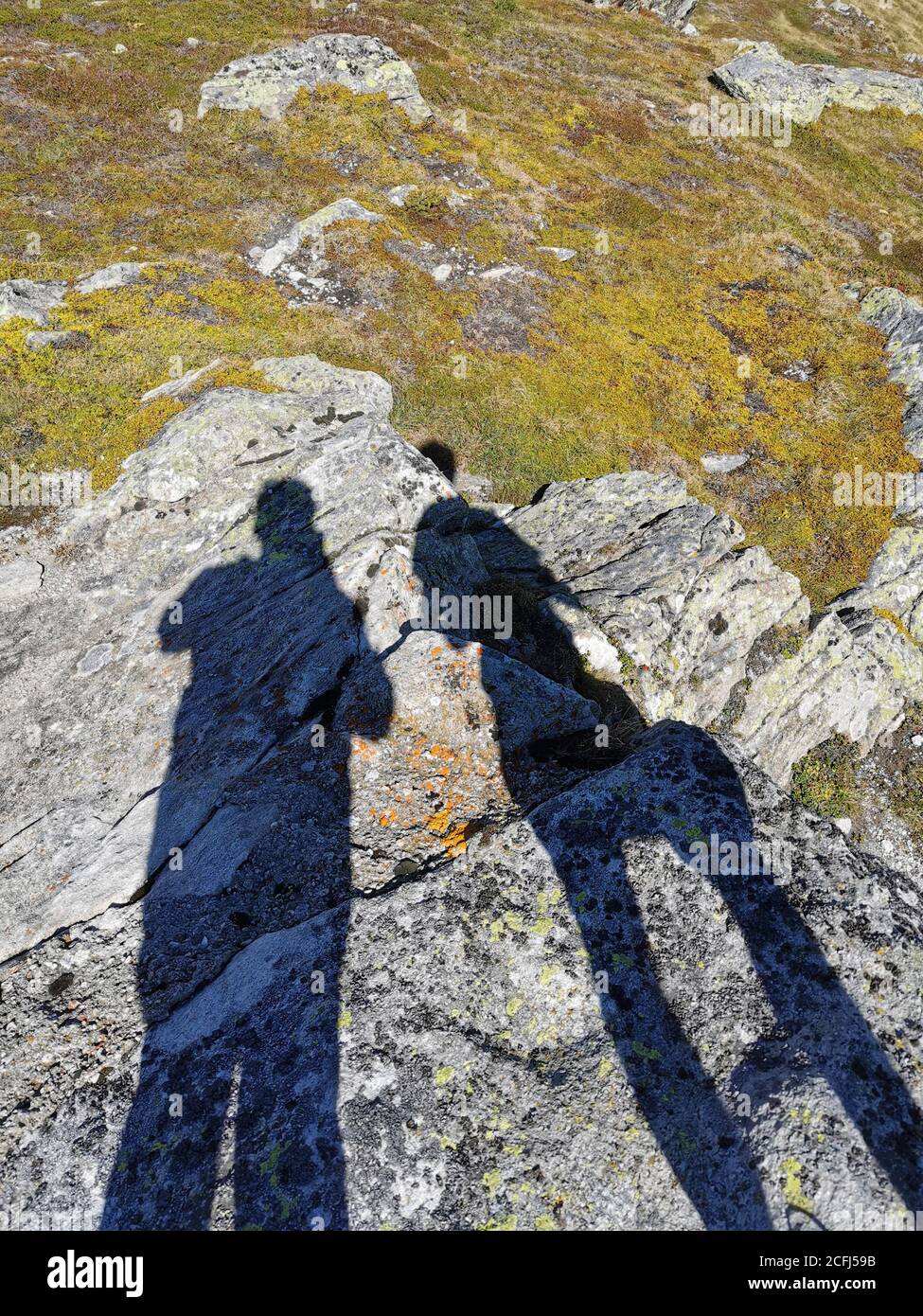 silhouette of tow photographers on rocks in Swiss alps Stock Photo