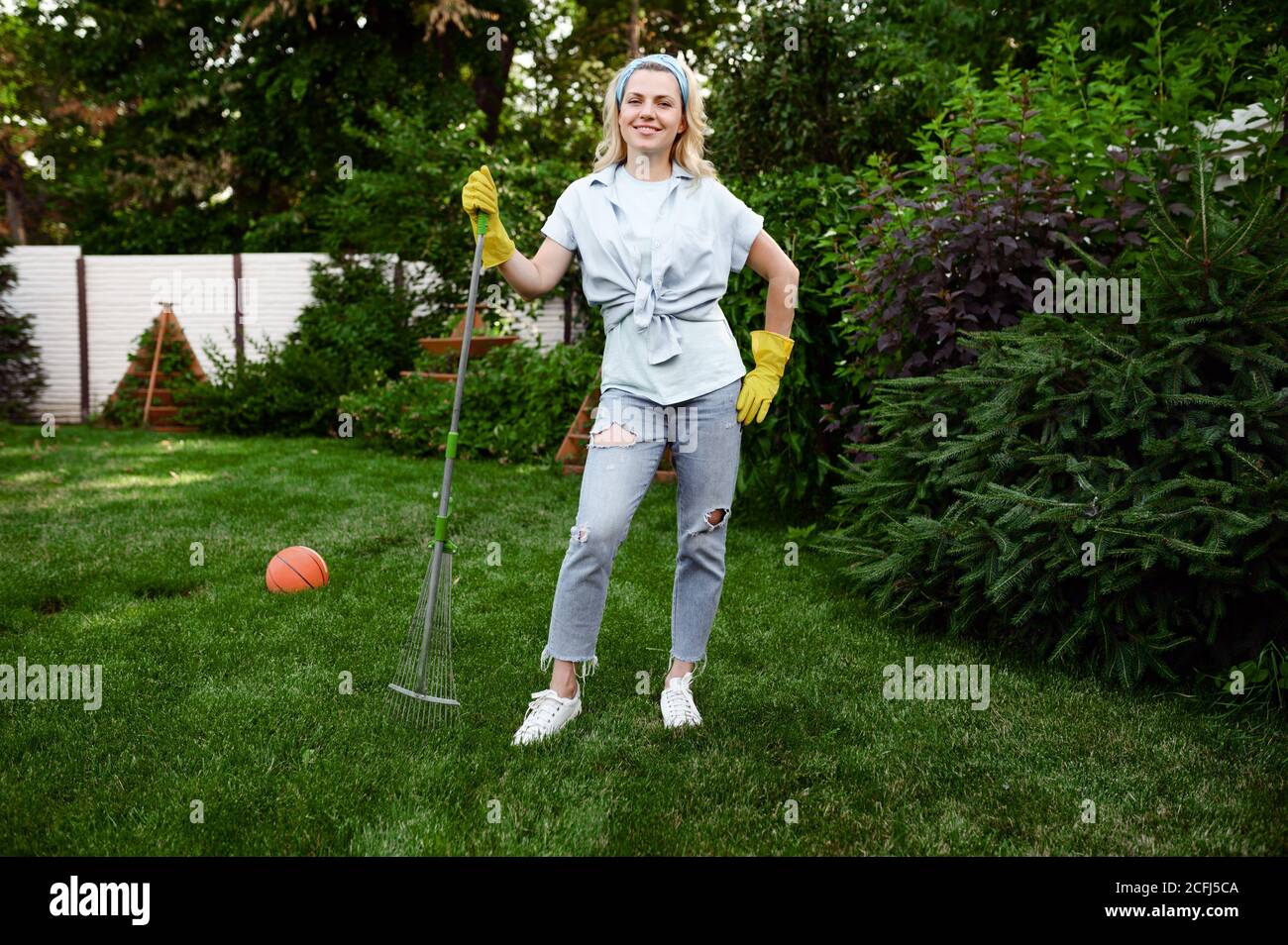 Woman with rake hi-res stock photography and images - Alamy