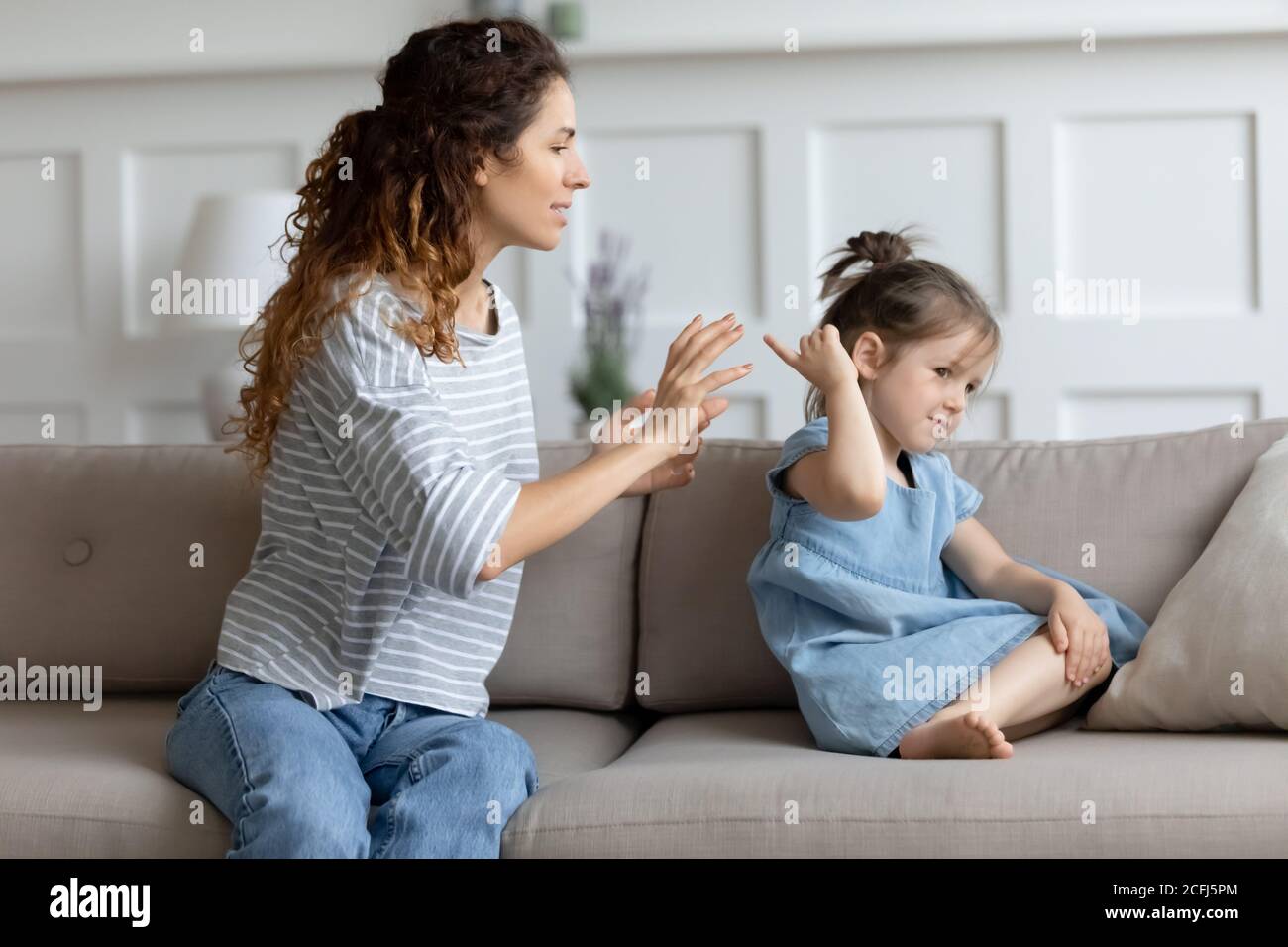 Young mother scolding naughty little misbehave daughter Stock Photo
