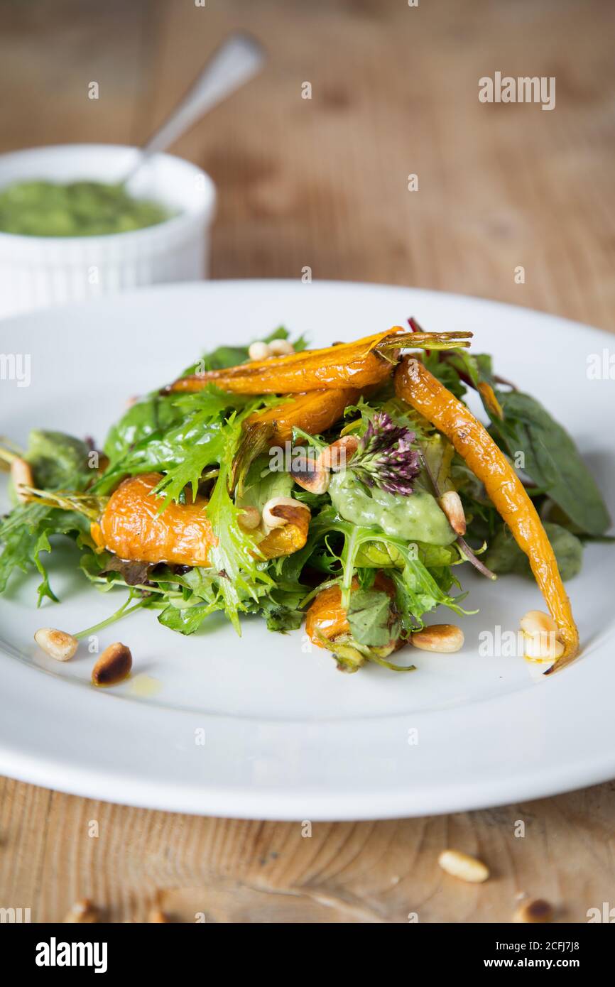 Roast carrots with pinenuts Stock Photo