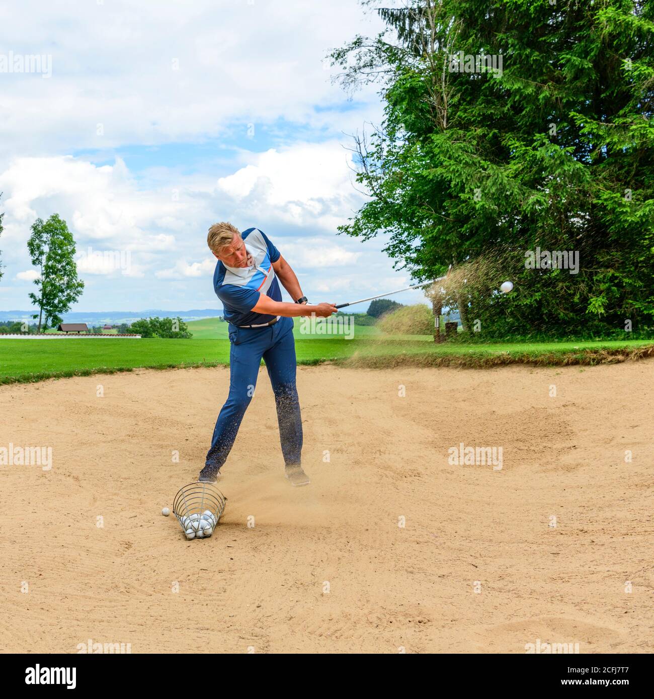 Golf lesson with pro in bunker Stock Photo