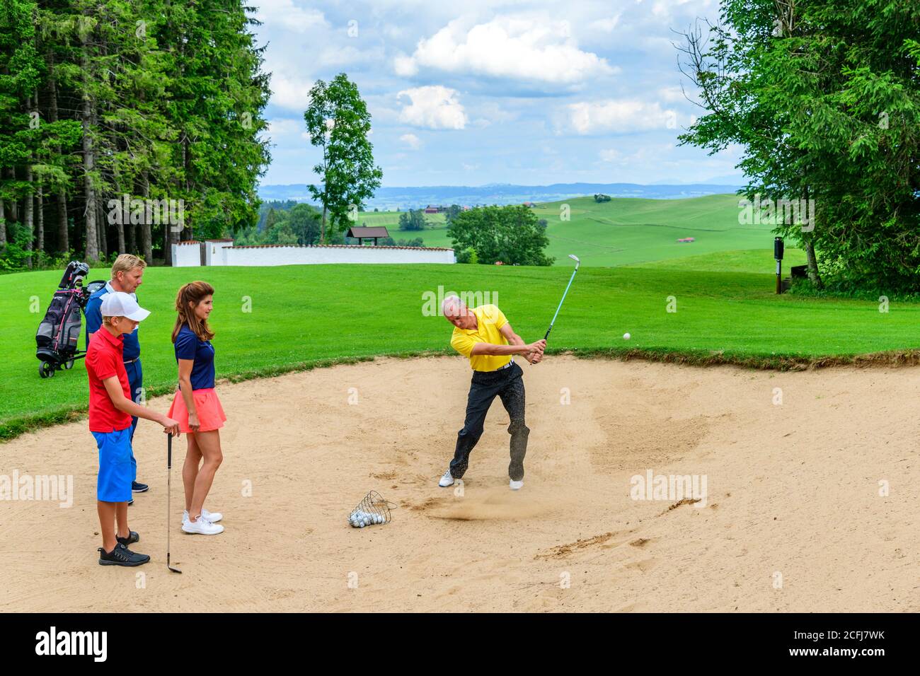 Golf lesson with pro in bunker Stock Photo