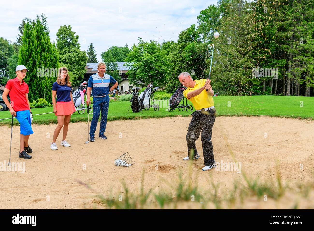 Golf lesson with pro in bunker Stock Photo