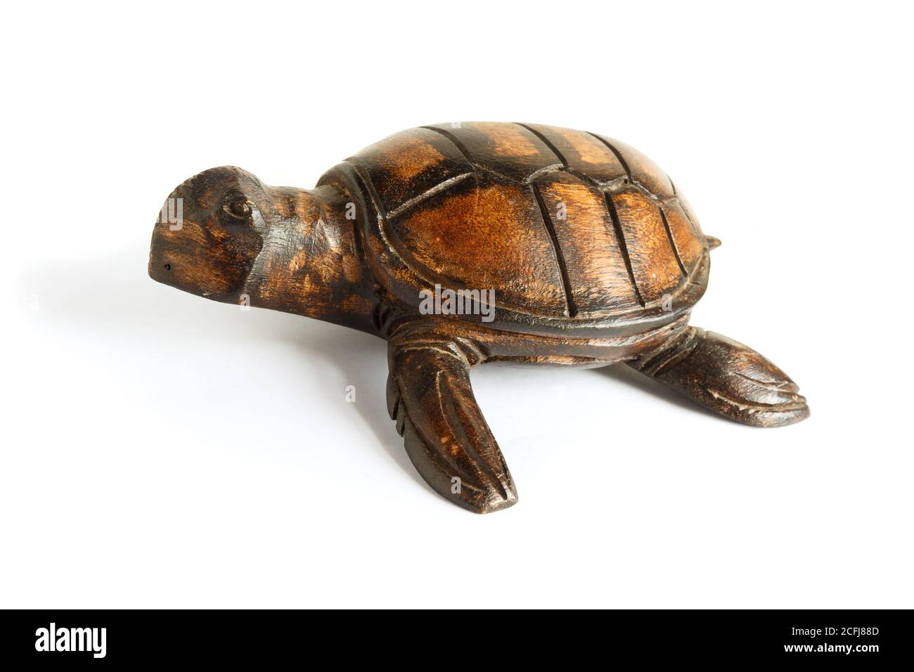 Wooden figurine of a sea turtle on a white background. Stock Photo