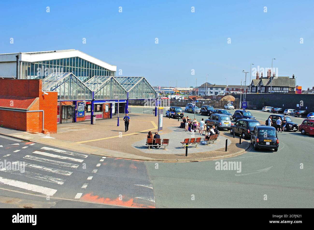 Tourists and taxis ouside Blackpool North railway station on a warm and sunny afternoon Stock Photo