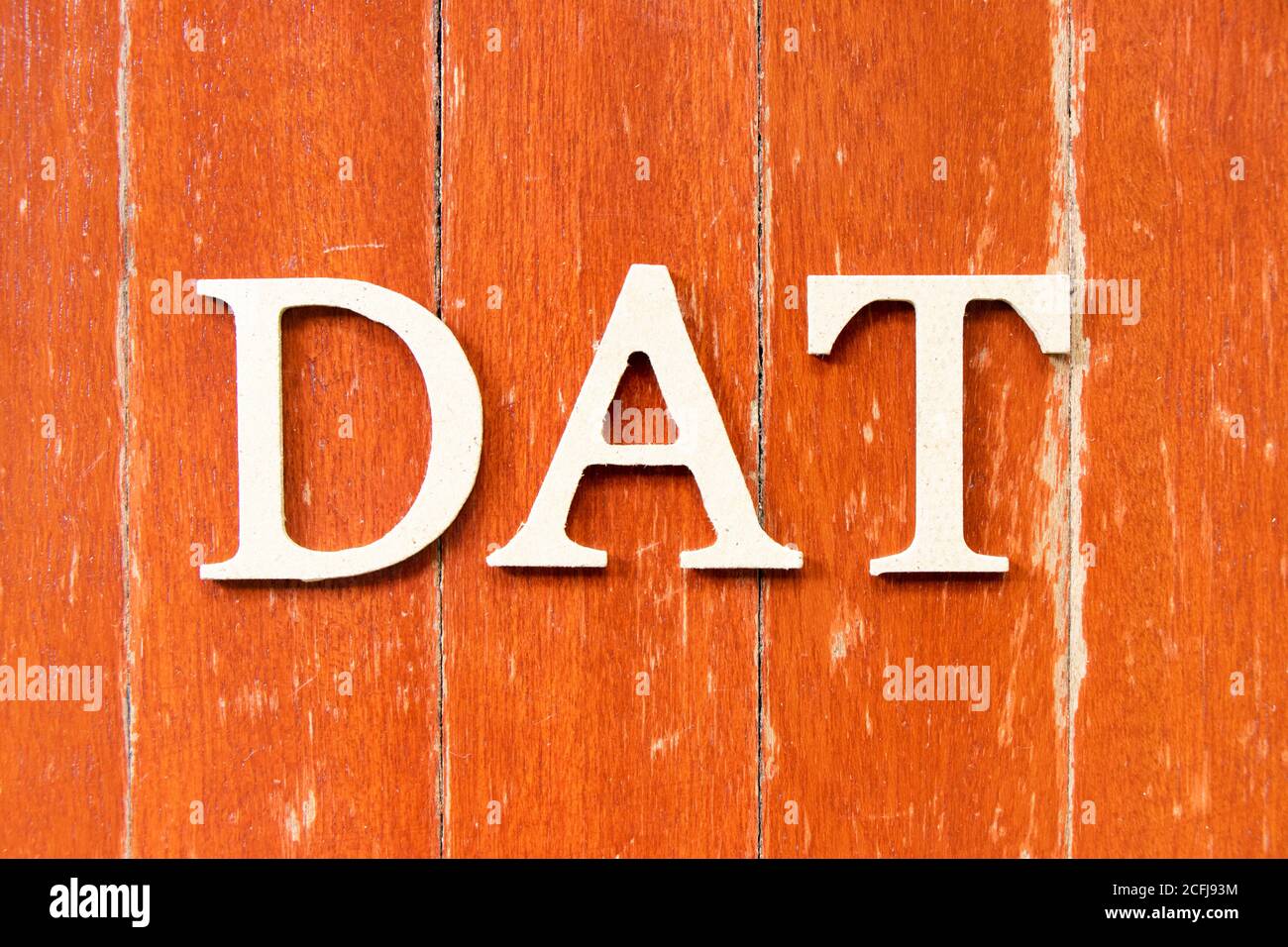 Alphabet letter in word DAT (Abbreviation of Delivery at Terminal) on old  red color wood plate background Stock Photo - Alamy