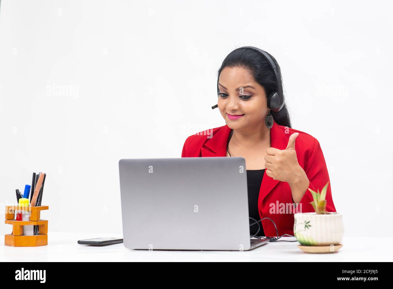 Portrait of professional Indian businesswoman wearing headphones and