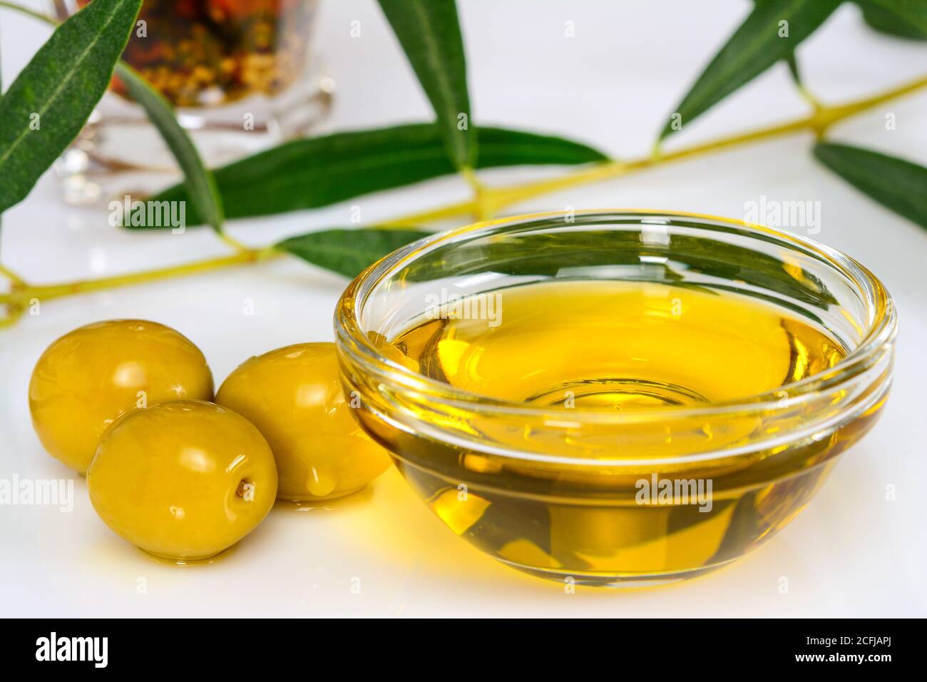 Olive oil. Greek olive oil in glass transparent bowl with leaves and ...