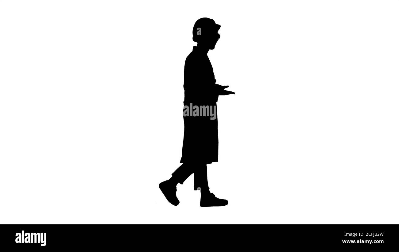 Silhouette Woman engineer walkin and talking emotionaly. Stock Photo