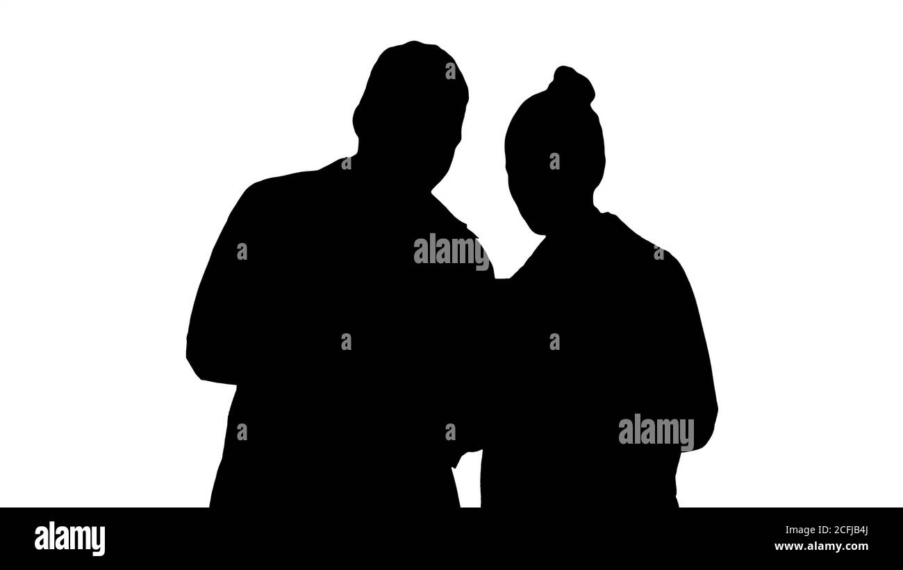 Silhouette Medical staff working in front of a grey laptop while standing. Stock Photo