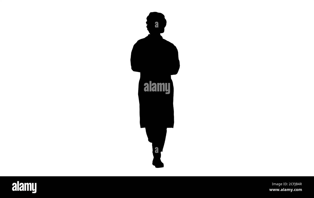 Silhouette Friendly female doctor walking and talking to camera. Stock Photo