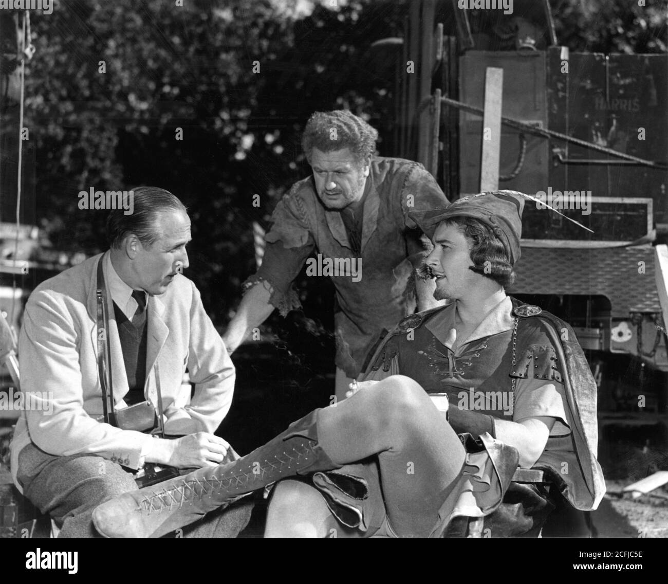 Director WILLIAM KEIGHLEY ALAN HALE and ERROL FLYNN on set location candid in Chico California during filming of THE ADVENTURES OF ROBIN HOOD 1938 directors MICHAEL CURTIZ and WILLIAM KEIGHLEY music Erich Wolfgang Korngold Warner Bros. Stock Photo