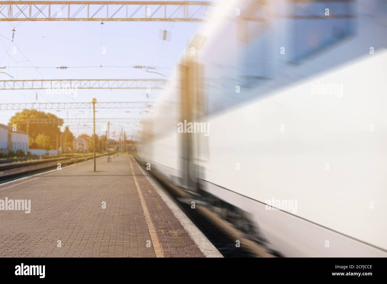 High speed train runs on rail tracks in the city Stock Photo Alamy