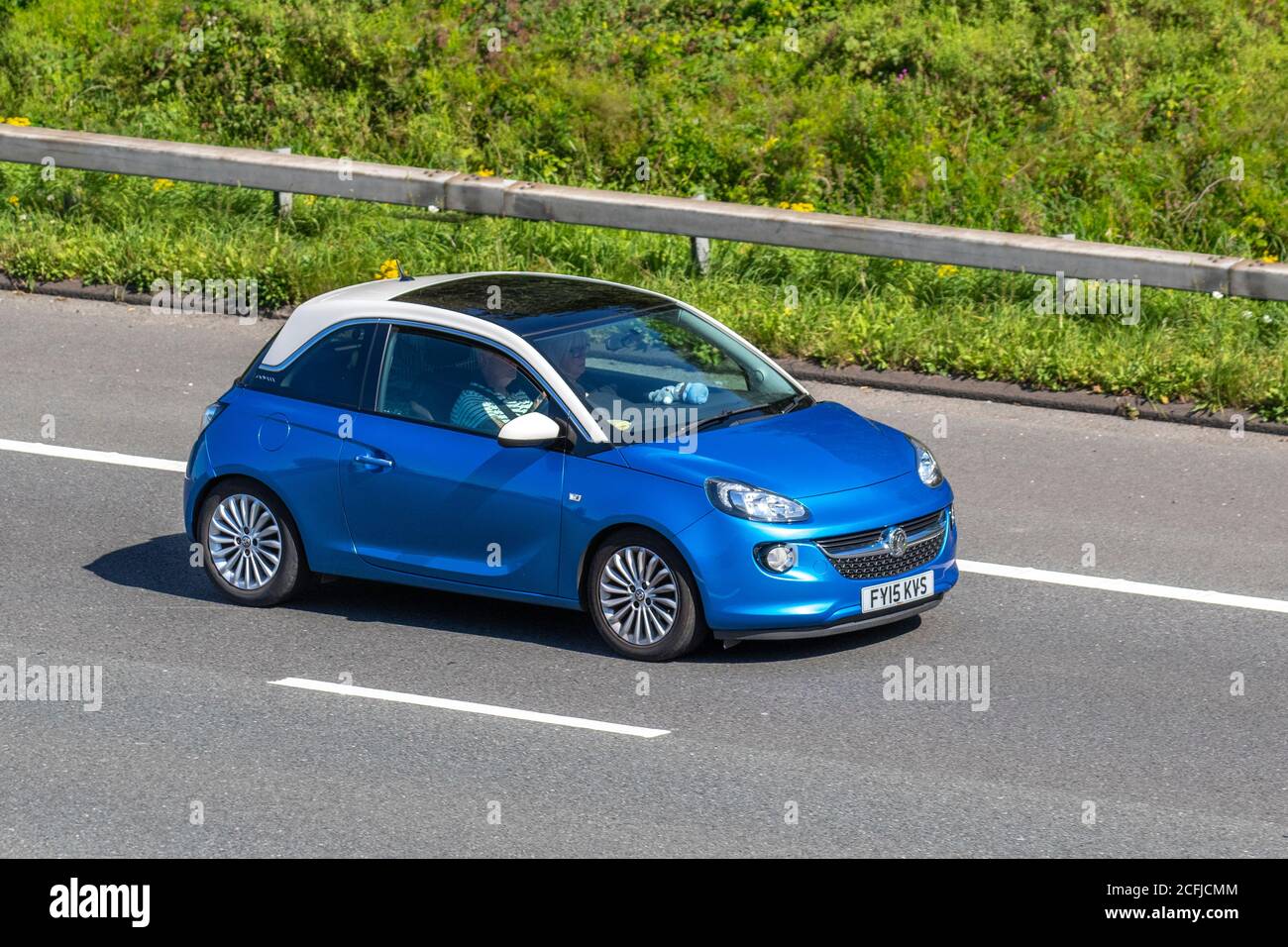 2015 blue Vauxhall Adam Glam; Vehicular traffic moving vehicles, cars driving vehicle on UK roads, motors, motoring on the M6 motorway highway network. Stock Photo