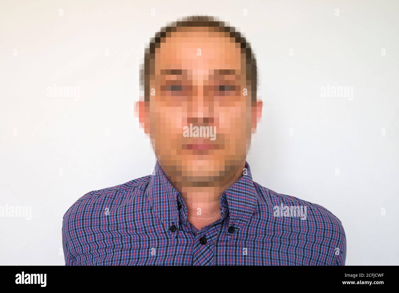 Portrait of a man with pixelated face in an concept of anonymity or GDPR Stock Photo