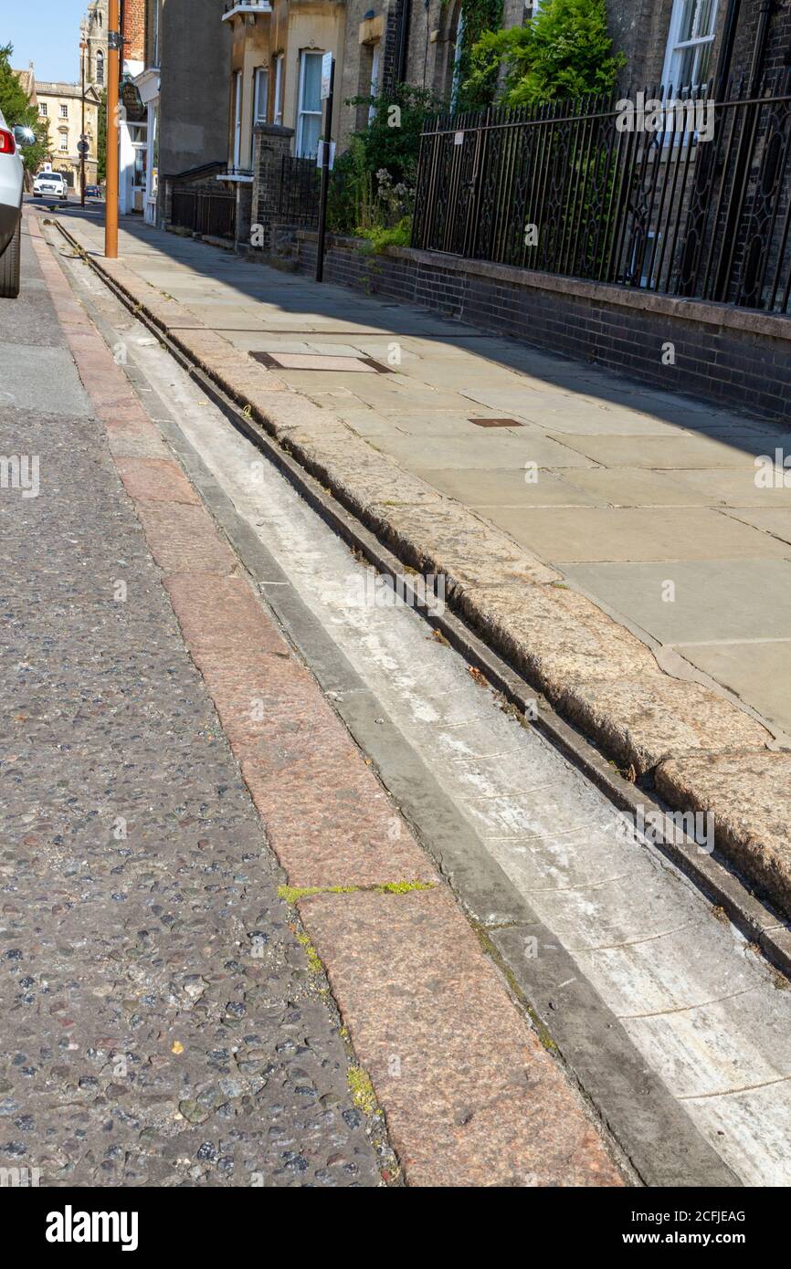 Deep road gutters on Trumpington Street, Cambridge, Cambridgeshire, UK. Stock Photo