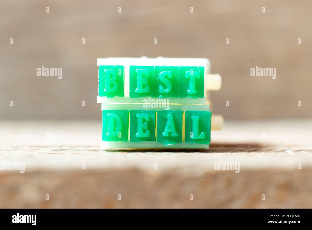 Green color rubber stamp in word best deal on wood background Stock