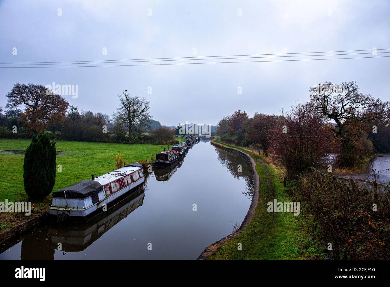 Narrow boats on the Trent and Mersey canal in winter near Sandbach Cheshire UK Stock Photo