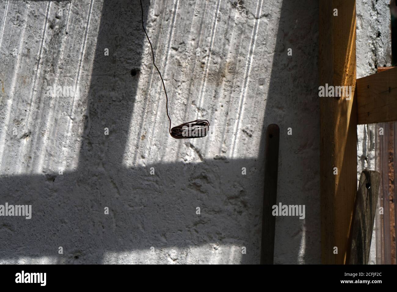 Old cracked wall with a window shadow on it Stock Photo