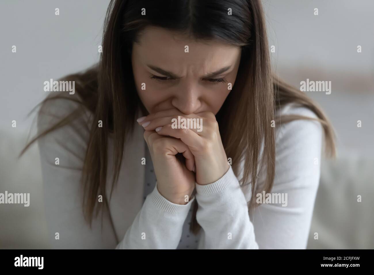 Stressed millennial woman worrying about hard decision. Stock Photo