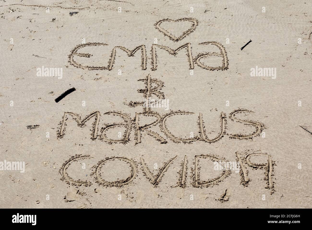 Writing in sand on the beach at Whitby, England, during the 2020 Coronavirus pandemic. Stock Photo