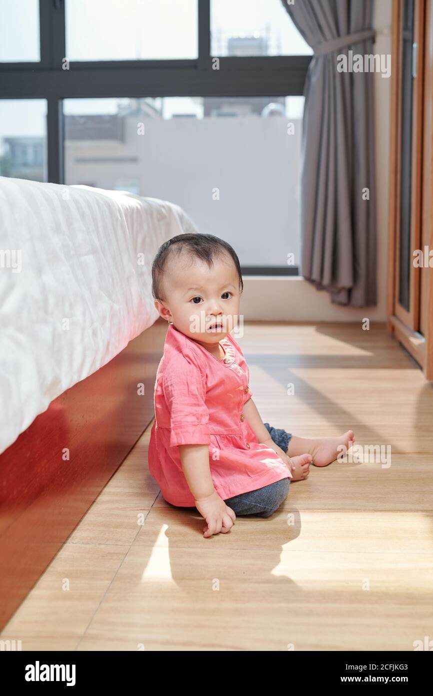 Girl sitting on the floor Stock Photo - Alamy