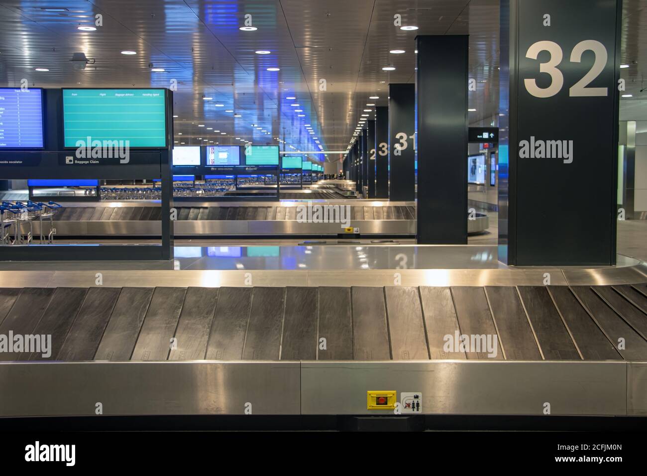 Empty rows of conveyor belts for luggage at the airport. Terminal of airport without people. Stock Photo