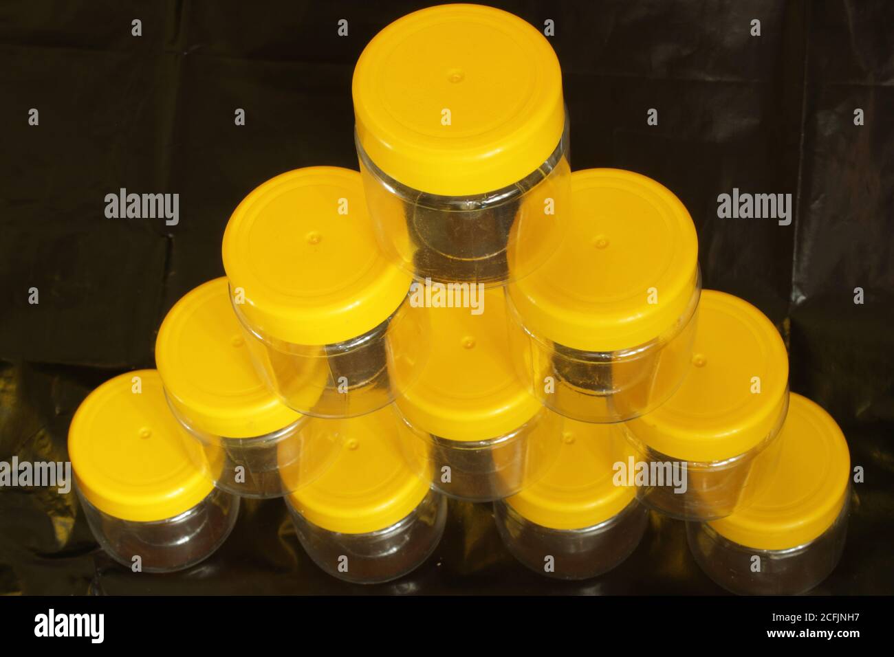 Empty jars ready for filling on a black background Stock Photo