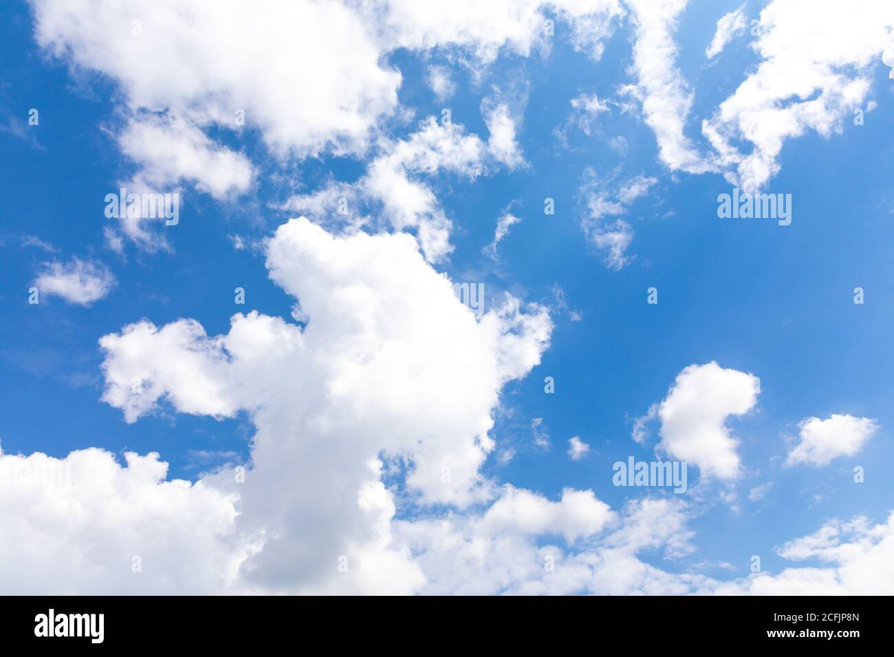 Low angle shot of a bright blue sky with clouds Stock Photo - Alamy