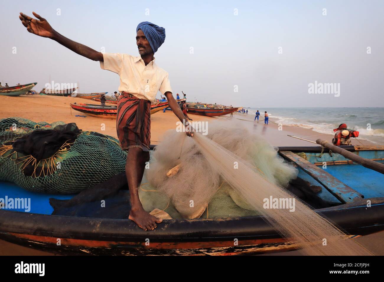 Fisherman on the beach near the traditional fishing colony in Puri, Odisha, India Stock Photo