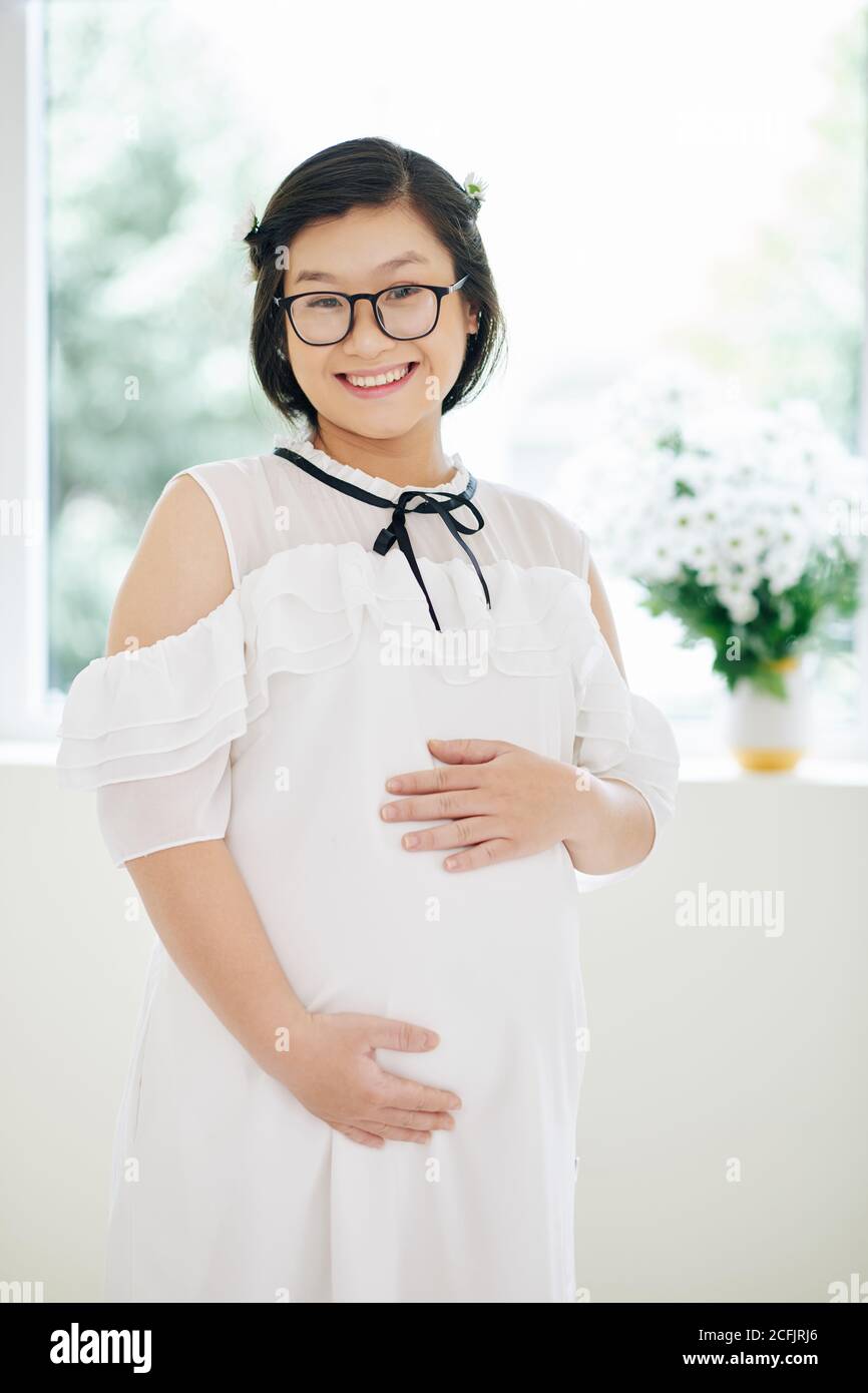 Smiling pregnant young woman Stock Photo