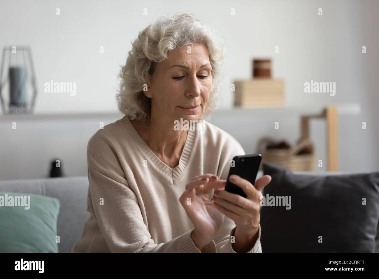 Woman middle aged looking phone hi-res stock photography and images - Alamy