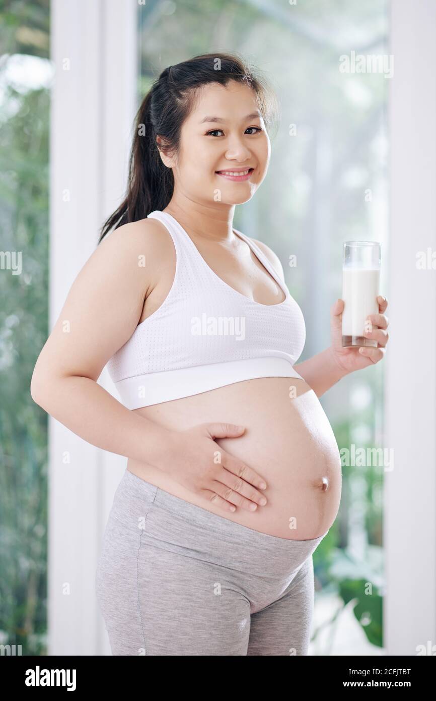 Pregnant woman drinking yogurt Stock Photo Alamy