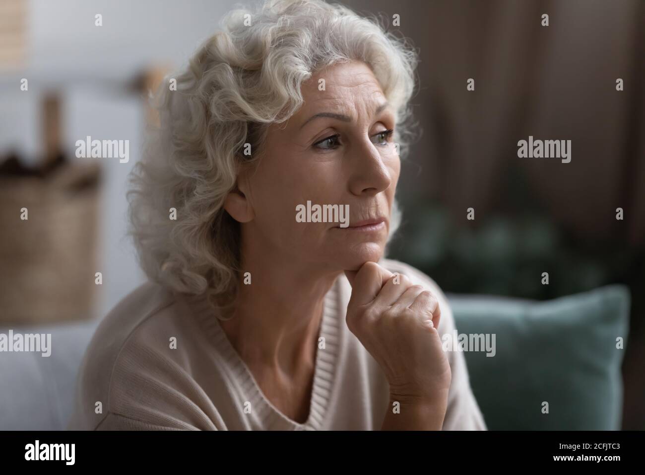 Close up thoughtful middle aged woman looking to aside Stock Photo