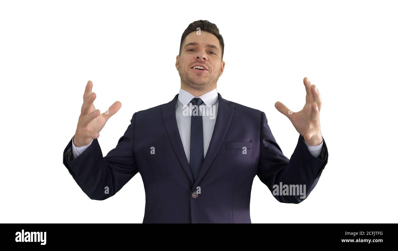 Man in formal clothes speaking to camera doing hand gestures in a very expressive and positive way on white background. Stock Photo