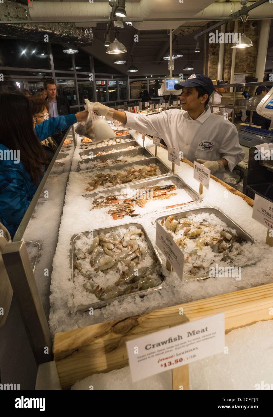 Chelsea Market, New York City - 18th May 2016: People buying fresh fish at the Chelsea market in New York. The Chelsea Market has a variety of food ma Stock Photo