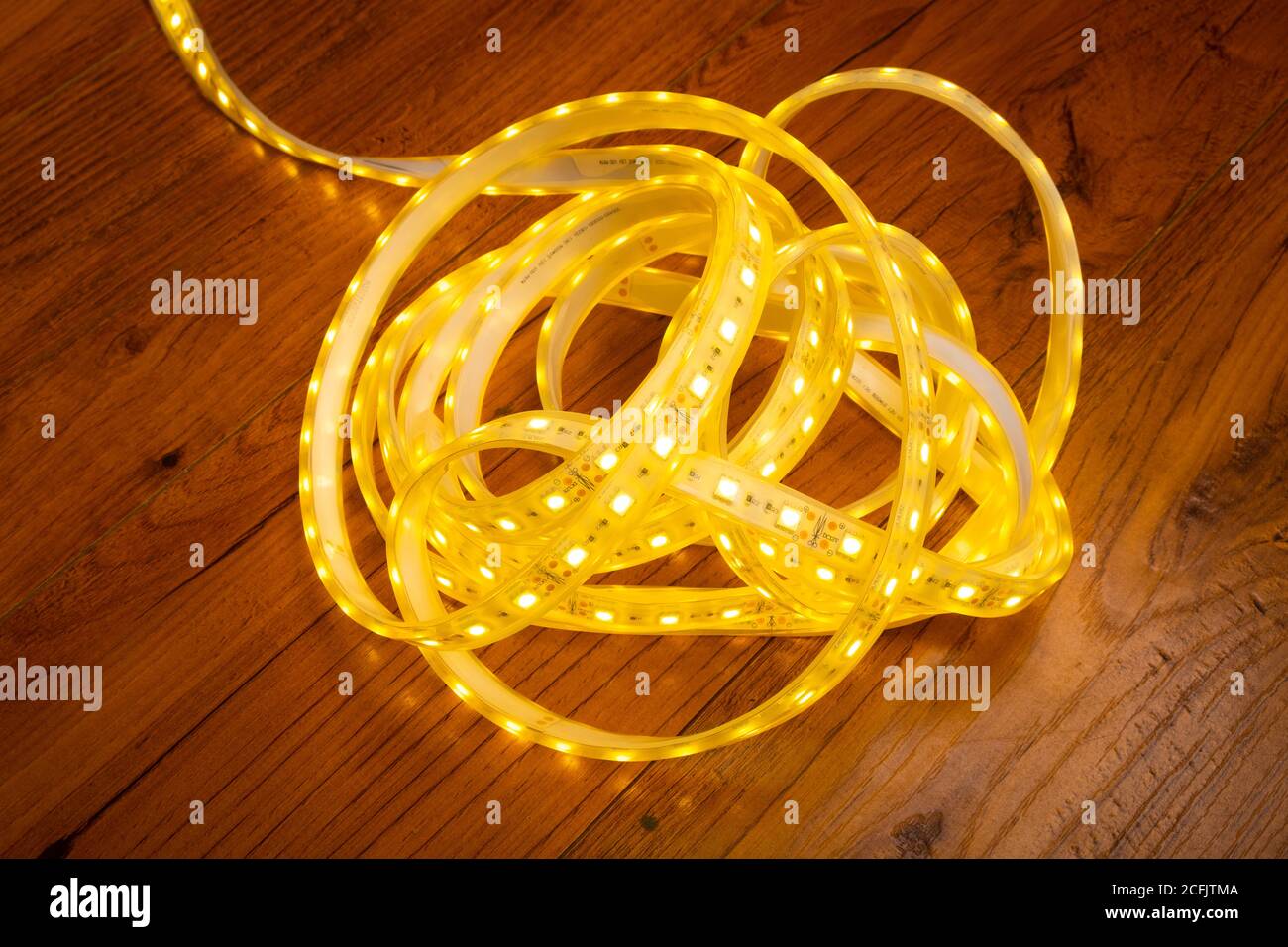 skein of led strip with warm yellow light close-up. Stock Photo