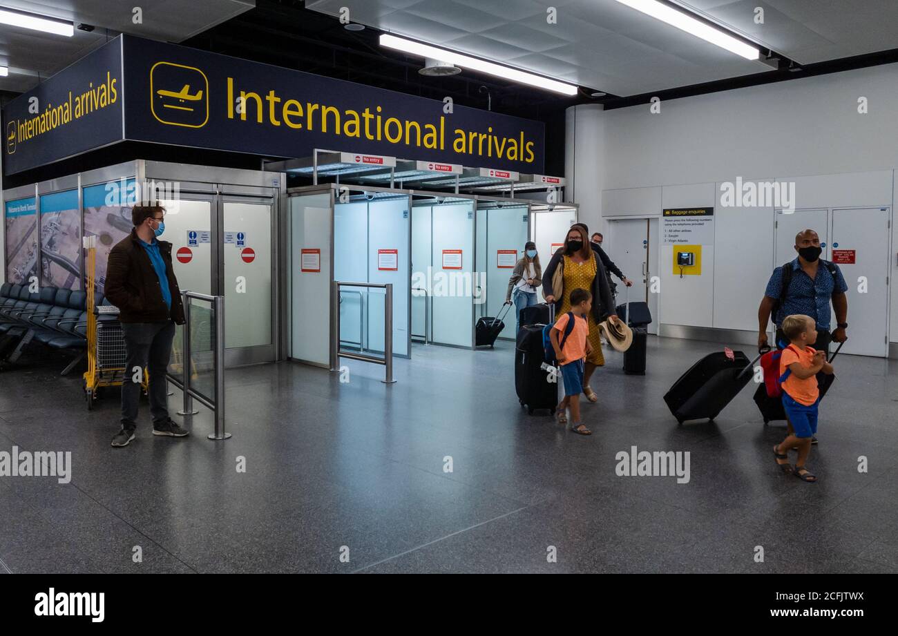 Air passengers emerging from the international arrivals gates in Gatwick airport north terminal. Stock Photo
