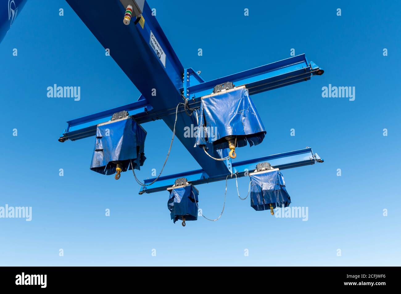 Boat Crane lift on a blue sky background Stock Photo