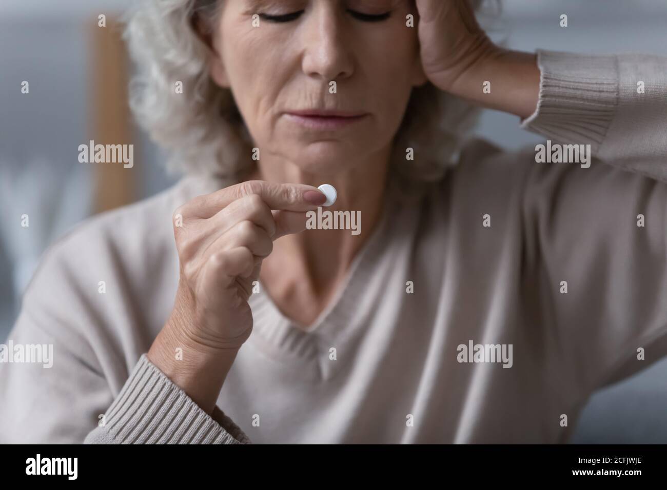 Close up unhappy sick mature woman suffering from headache Stock Photo